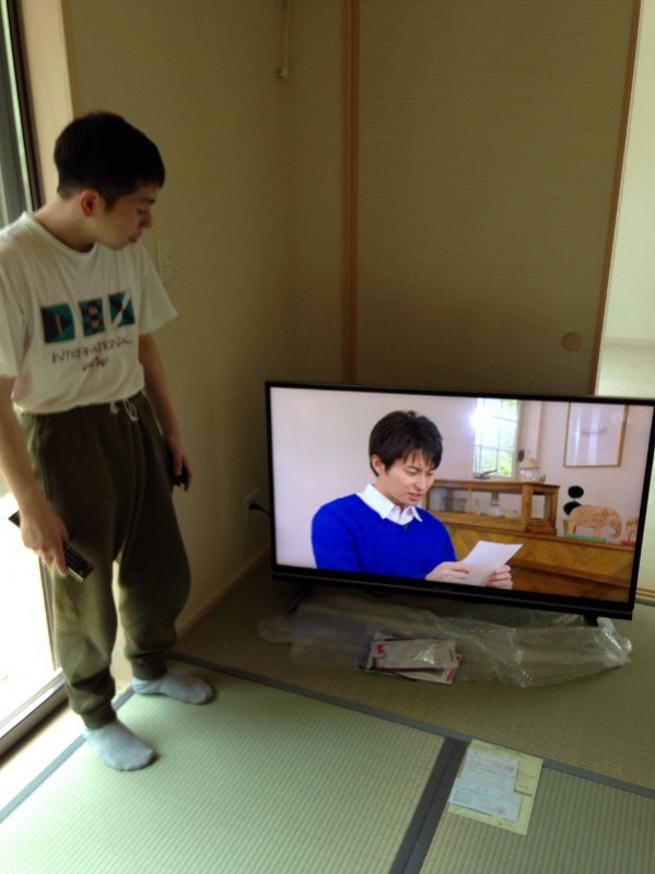 テレビ横の男性