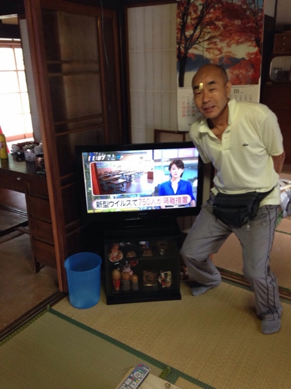 テレビ横の男性