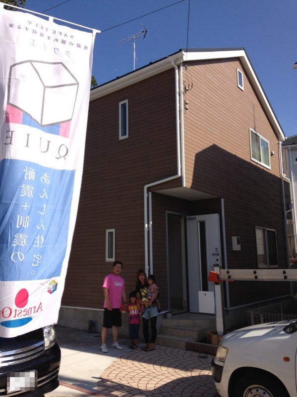 戸建住宅前の家族